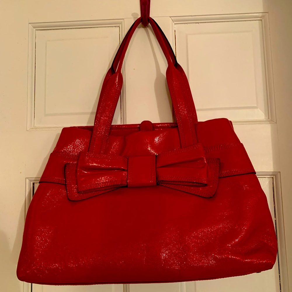 Red patent leather Kate Spade handbag. Dimensions 15”W 10”H 5”D. Almost new.